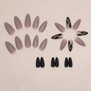 Elegant almond-shaped press-on nails in matte grey-purple and black with gold linear accents