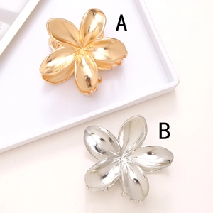 Elegant gold and silver metal plumeria hair claw clips set with a high-polished finish