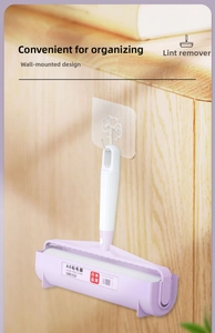 Wall-mounted lint roller in purple showing convenient storage on wooden background