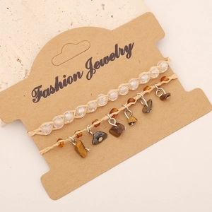 Detail of bohemian handmade bracelets set with natural stones and fashion jewelry tag