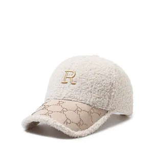 Detail of beige fleece baseball cap with embroidered R patch and rhinestone brim accents