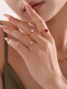 Detailed macro view of 18k gold plated stacking rings with colorful zircon center stones