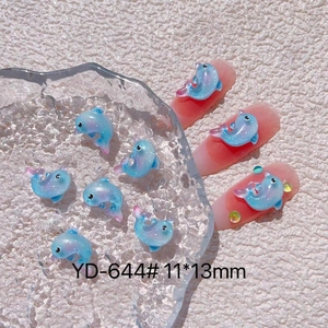 Detail view of 11x13mm light blue iridescent dolphin nail charm with glitter finish