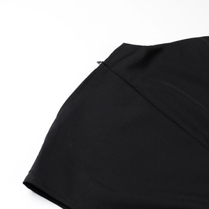 Detail shot of invisible zipper closure on high-quality black slim-fit dress fabric