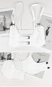 Detail showing white PU leather corset belt with metal buckles and stylish textured finish