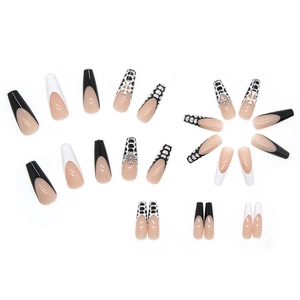Black and white long coffin press-on nails with silver cross accents and speckled patterns