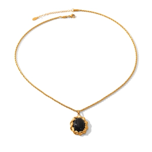 Detail of vintage gold-plated twist chain necklace with black gemstone oval pendant