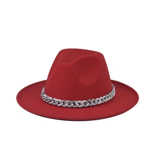 Detailed shot of a red wool fedora hat featuring a stylish grey marble chain band