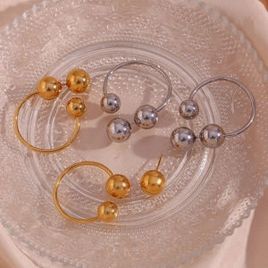 Minimalist 18K gold and silver plated triple ball hoop earrings on a glass tray