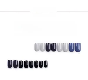 Detail view of multi-colored short square press-on nails with glossy polished finish