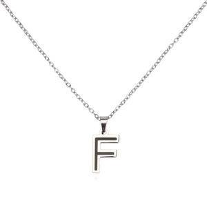 Macro detail of F letter pendant with black inlay and silver stainless steel cross chain