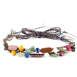 Detail showing bohemian multi-layer braided bracelet with colorful beads on white background