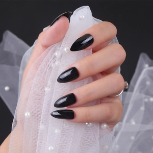 Glossy black pointed press-on nails with long stiletto shape and shiny UV finish