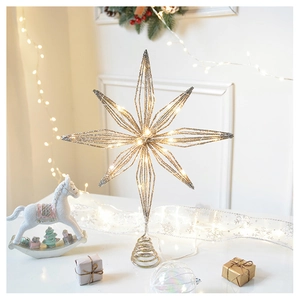 Close-up of a hollow metal Christmas tree star topper with silver glitter and warm LED lights