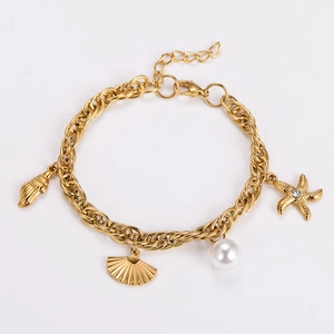 Detail showing the gold chain links, starfish charm, and shells of the ocean pearl bracelet