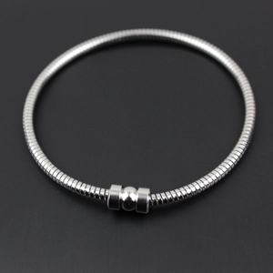 Macro detail of silver stainless steel snake chain bracelet with cylindrical clasp closure