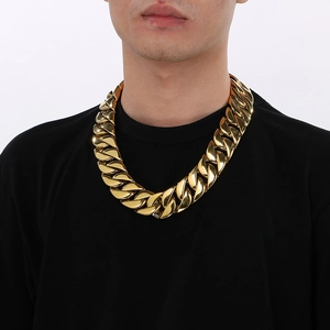 Close-up of a 31mm thick gold-plated stainless steel Cuban link chain necklace on a male model