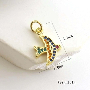 Detailed view of a gold bird charm with colorful zircon stones including size measurements