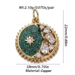 Detail of gold star and moon pendant with dark green glitter and clear zircon stones