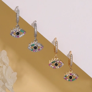 Gold and silver evil eye huggie hoop earrings with colorful cubic zirconia stones