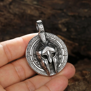 Silver Viking warrior helmet pendant with Greek key pattern border on round metal base