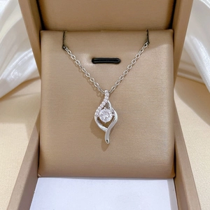Detail of silver necklace with a spiral pendant and central zircon in a jewelry box