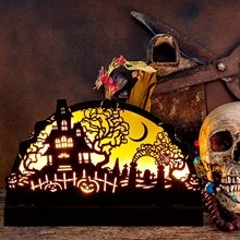 Detail of wooden Halloween LED lantern featuring haunted castle and pumpkin silhouettes