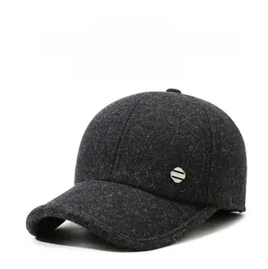 Detail view of winter baseball cap with ear flaps and thickened wool-like fabric in grey