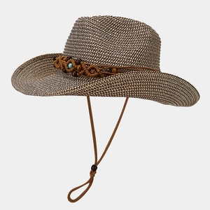 Detailed close-up of woven cowboy straw hat featuring turquoise beads and wind rope