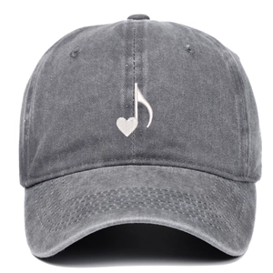 Detail view of washed gray cotton baseball cap with embroidered heart music note design