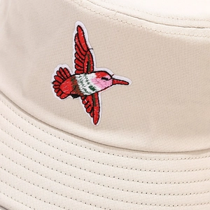 Close-up of beige canvas bucket hat with high-quality colorful hummingbird embroidery detail