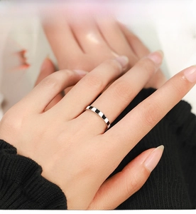 Detail view of a 925 sterling silver ring with classic black checkered enamel on the finger