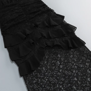 Detailed macro view of black lace fabric and tiered ruffle layers of the evening dress