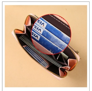 Detail view of the pink multi-card holder interior with a secure gold zipper pocket