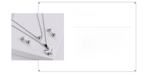Detail of 316L stainless steel double layer butterfly pendant and ball stud earrings