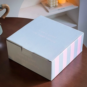 Detail of light blue ceramic dog mug gift box on a wooden table with elegant lettering