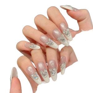 Handmade press-on nails featuring ice cat eye almond shape and sparkling 3D heart rhinestones