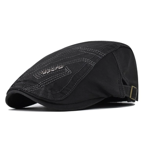 Detail view of cotton flat cap with gray stitching and metal Sports emblem on the side