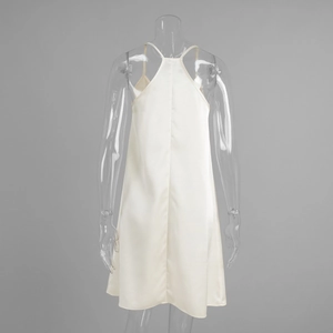 Detail view of the cream satin mini dress featuring a criss-cross back and thin straps