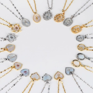 Collection of vintage French shell necklaces with heart and rose pendants in gold and silver