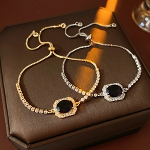 Detail of adjustable zircon bracelets in gold and silver with oval purple gemstones