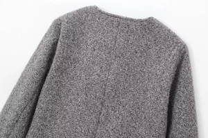Close-up of gray wool boucle jacket showing back collar detail and fabric texture