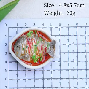 Close-up of 4.8x5.7cm braised fish food model magnet on a grid measurement mat