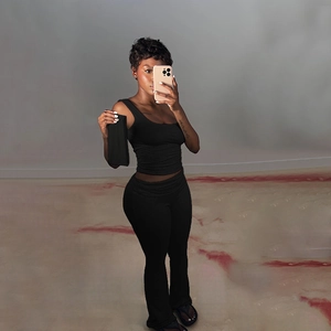 Detail of black U-neck tank top and high-waisted flared pants two-piece slim set