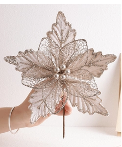 Close-up of champagne gold mesh Christmas flower with glitter and beaded center