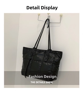 Macro shot of black quilted space cotton fabric and textured stitching on large tote bag
