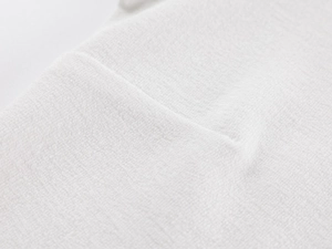 Detailed macro view of white cotton terry towel fabric texture with high density loops
