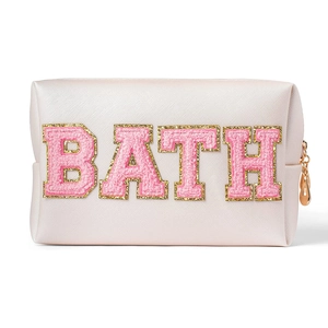 Pink woven makeup bag with glitter BATH chenille letters and gold zipper on white background