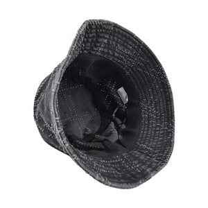 Close-up of distressed dark grey bucket hat with frayed edges and inner lining detail
