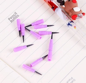 Close-up of lavender plastic non-sharpening pencil refills on a lined notebook page